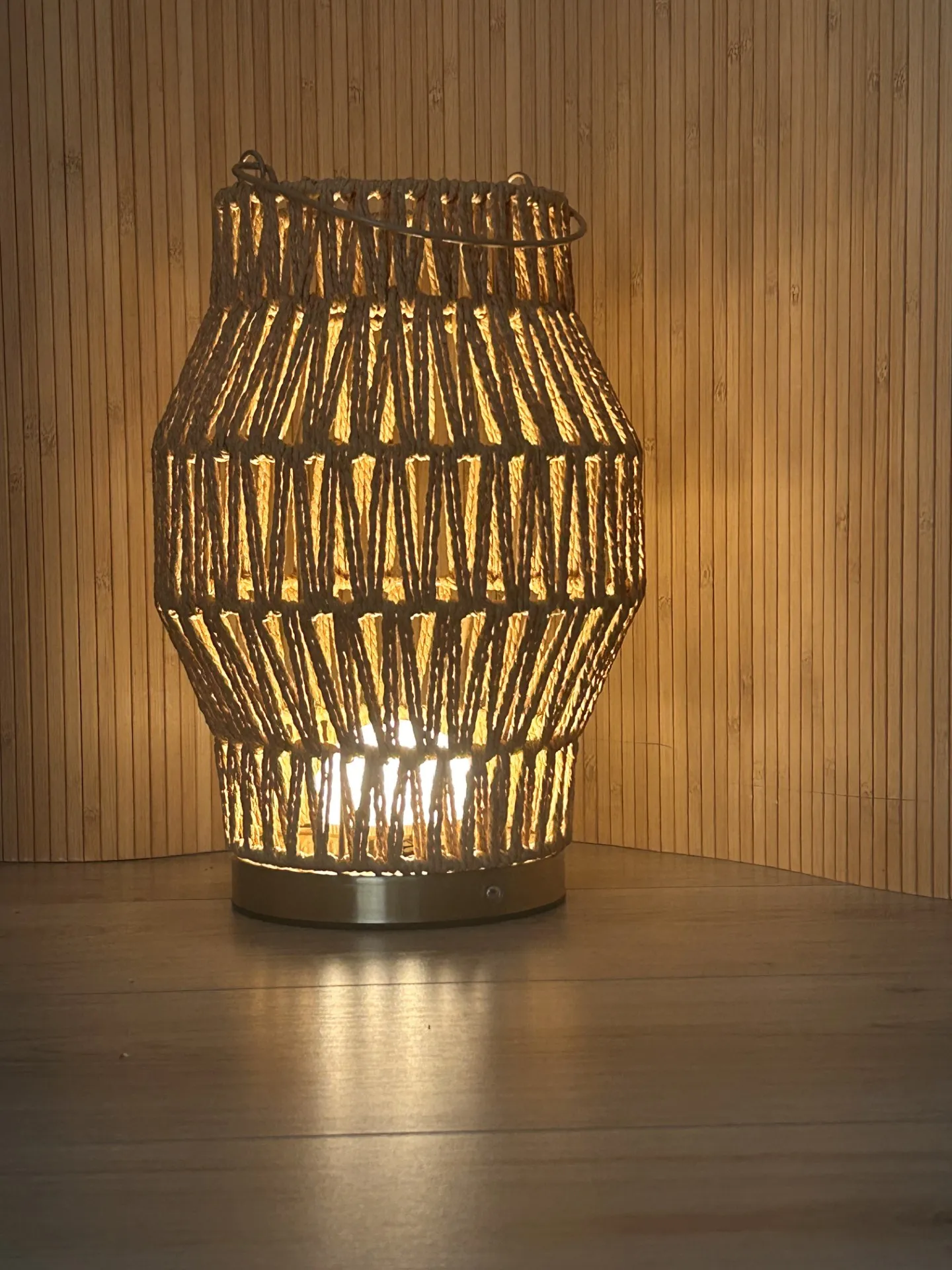 A warm woven lantern glowing softly in the treatment room
